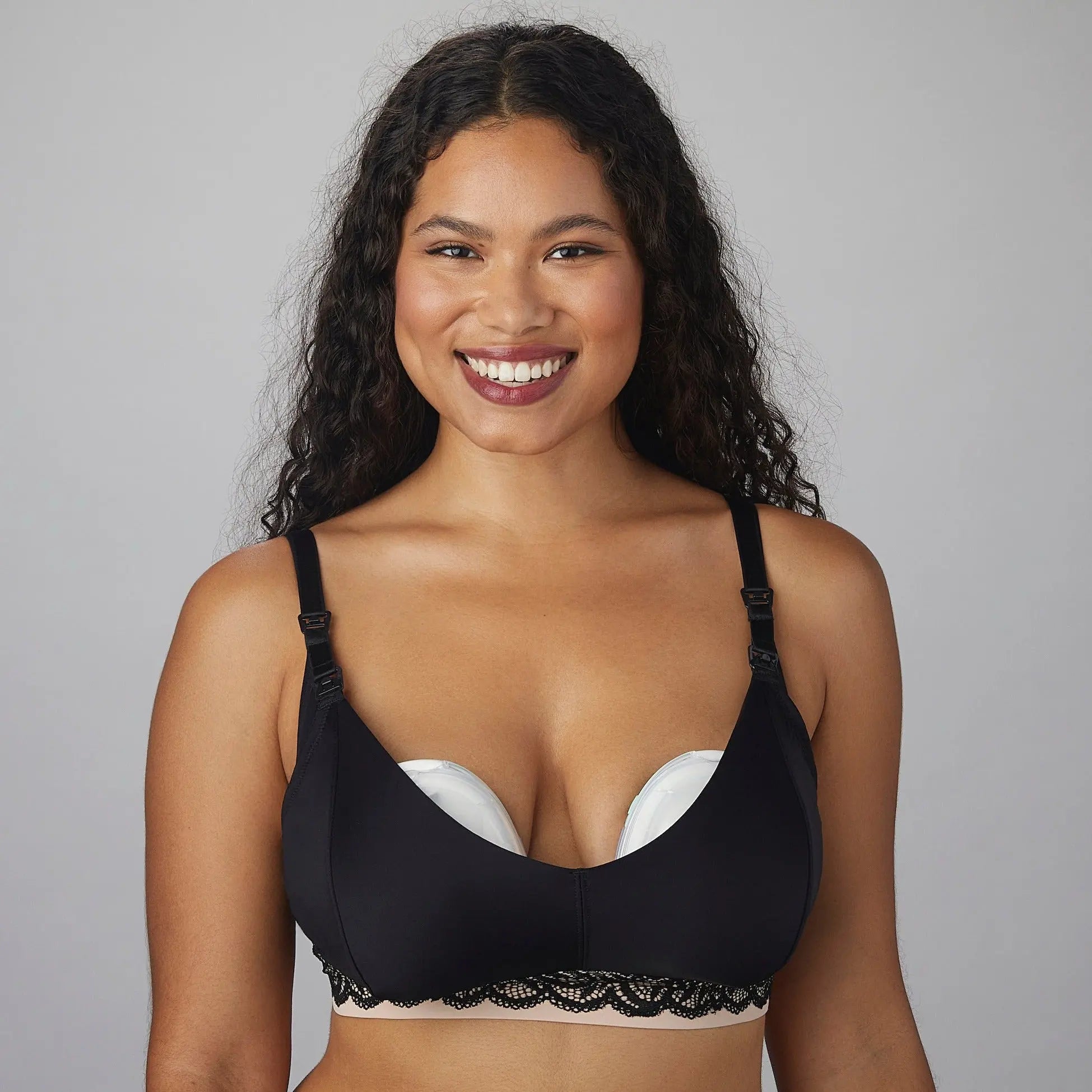 Luxe pumping bra black image from the front, woman lounging