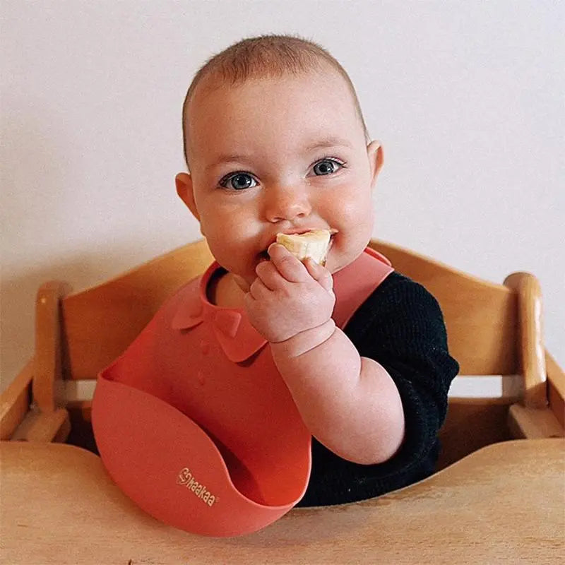 Silicone baby bib image from the front, baby eating