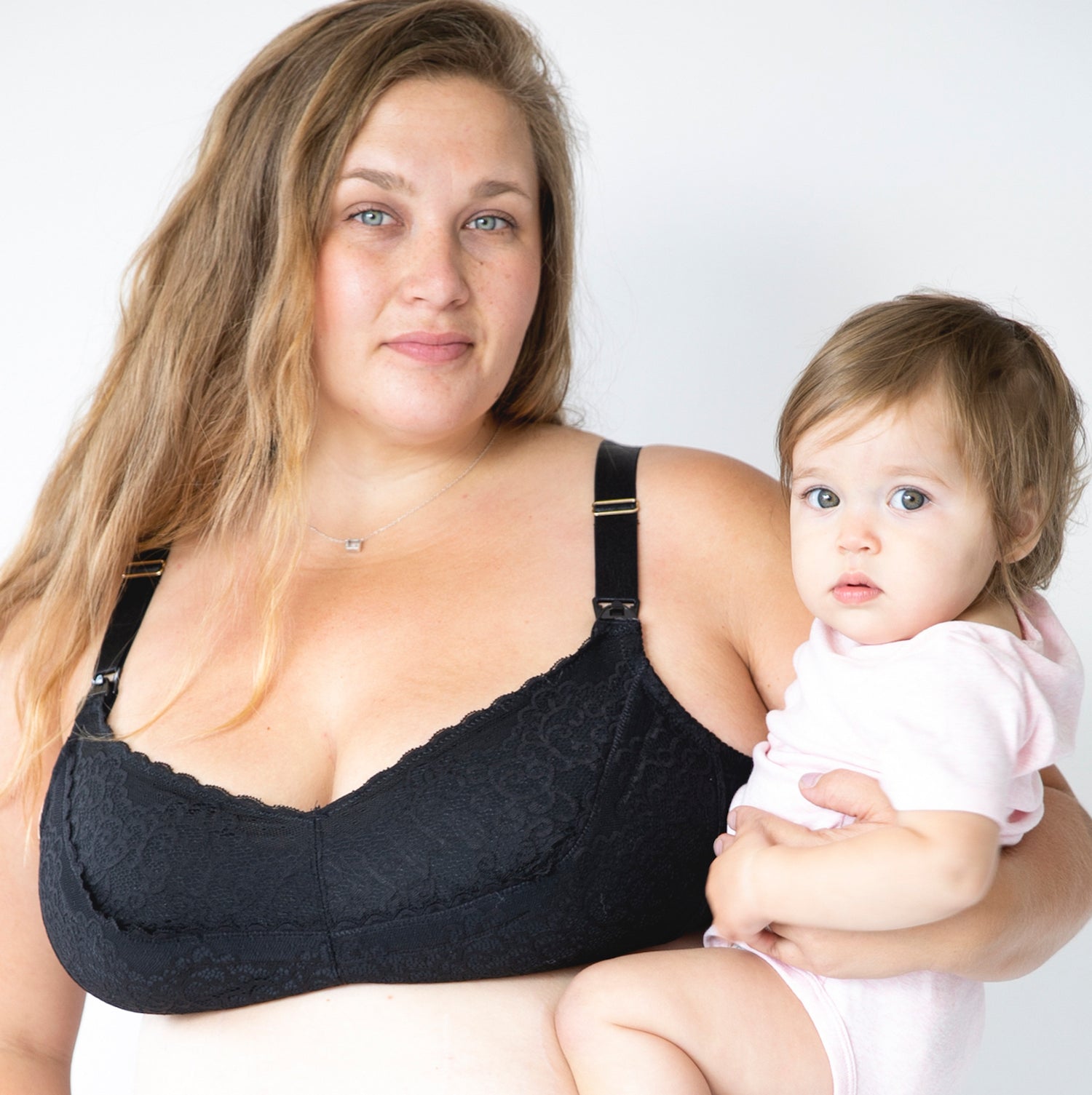 Mom holding baby in black bra