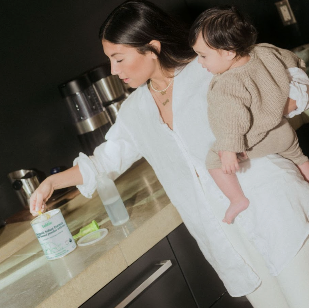 Mom preparing formula bottle